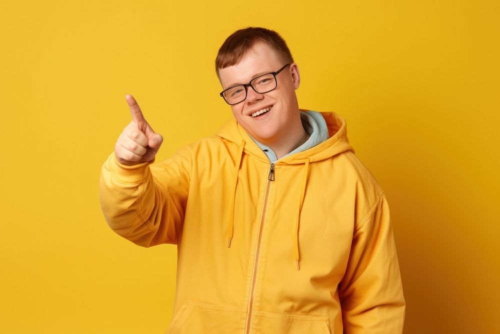 Young smiling man glasses holding yellow.