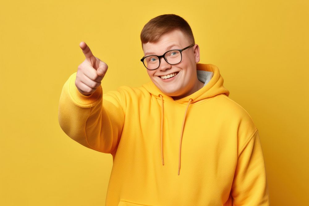 Young smiling man glasses yellow finger.
