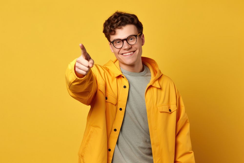 Young smiling man glasses holding yellow.