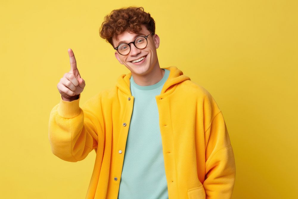 Young smiling man glasses yellow finger.
