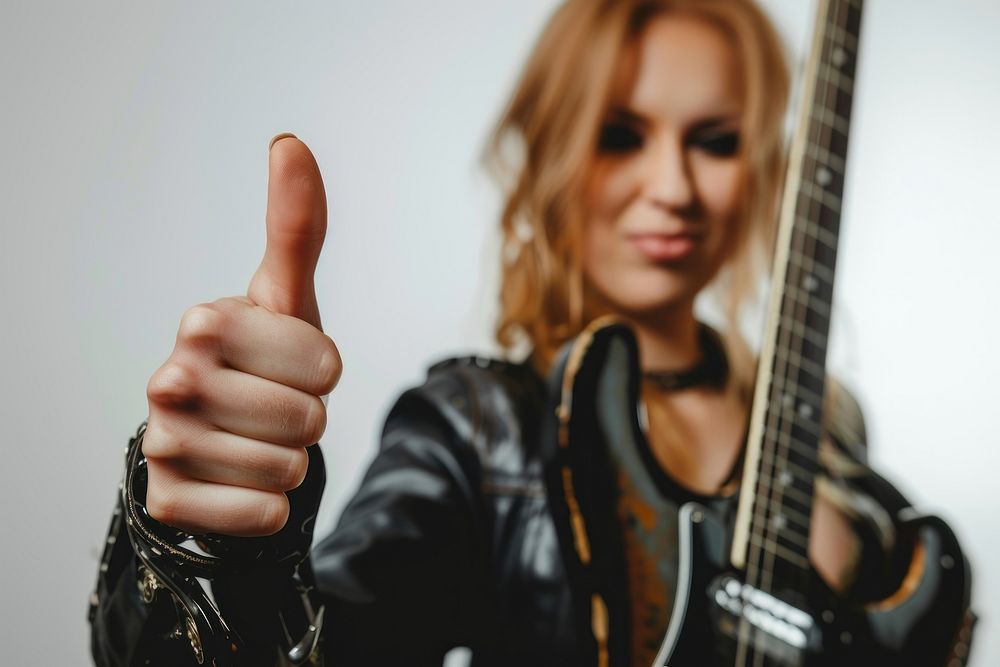 Women Thumbs up like a rocker finger musician guitar.