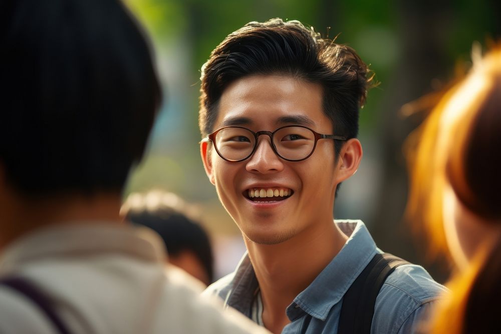 Asian person interacting with friends glasses smile togetherness.