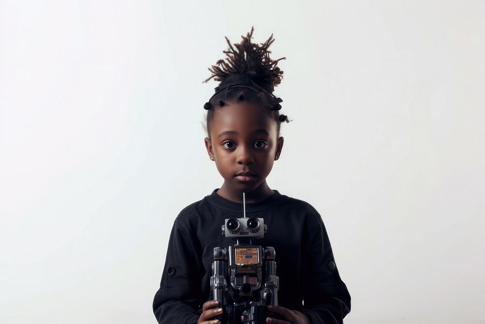 A black girl in front of a small robot portrait camera photo.