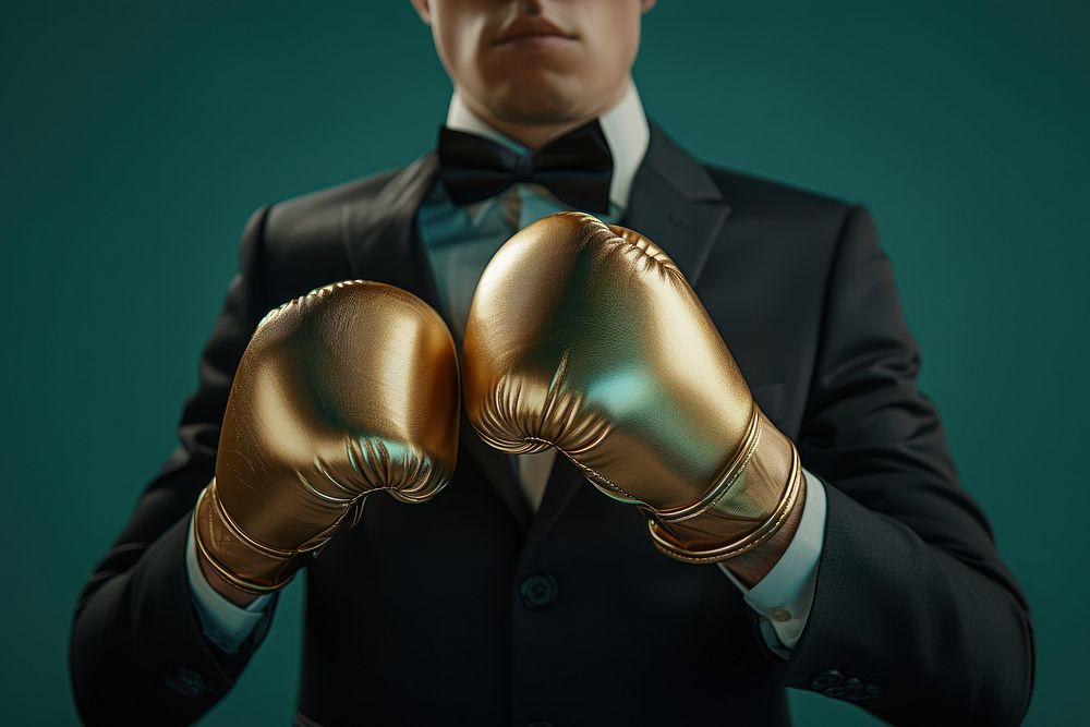 Businessman Wearing golden shining Boxing Gloves boxing punching sports.