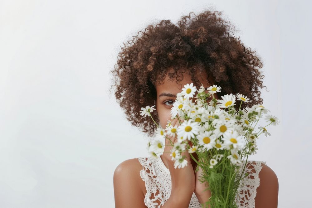 Young ethnic woman has problems with breathing holds nose suffers flower headshot plant.