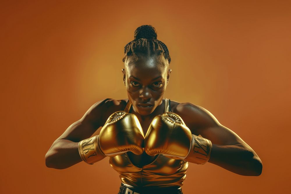 Women professional boxer Wearing golden shining Boxing Gloves boxing bodybuilding exercising.