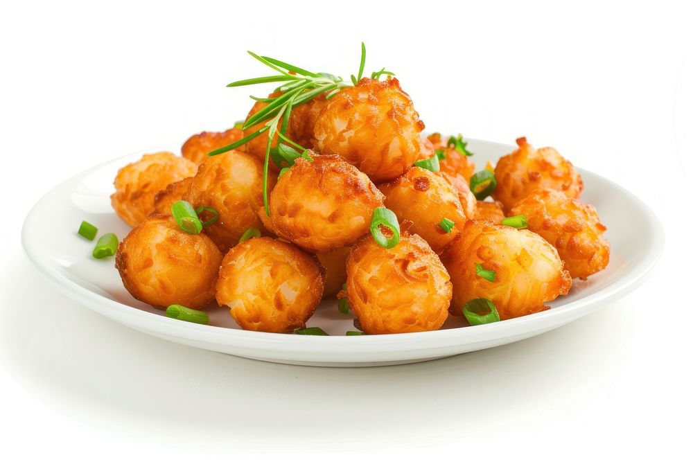 Tater tots on white plate food meat meal.