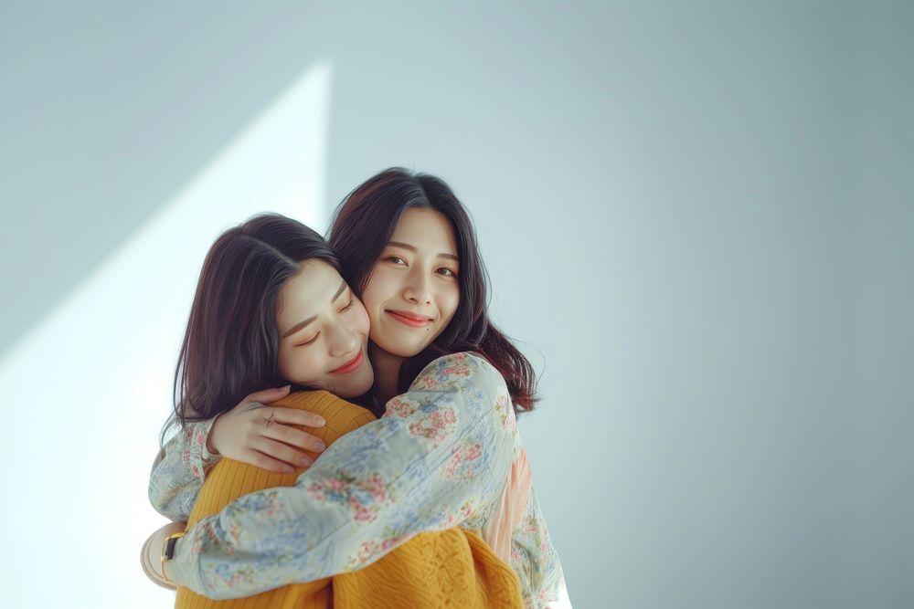 Two asian young women hugging affectionate togetherness friendship.