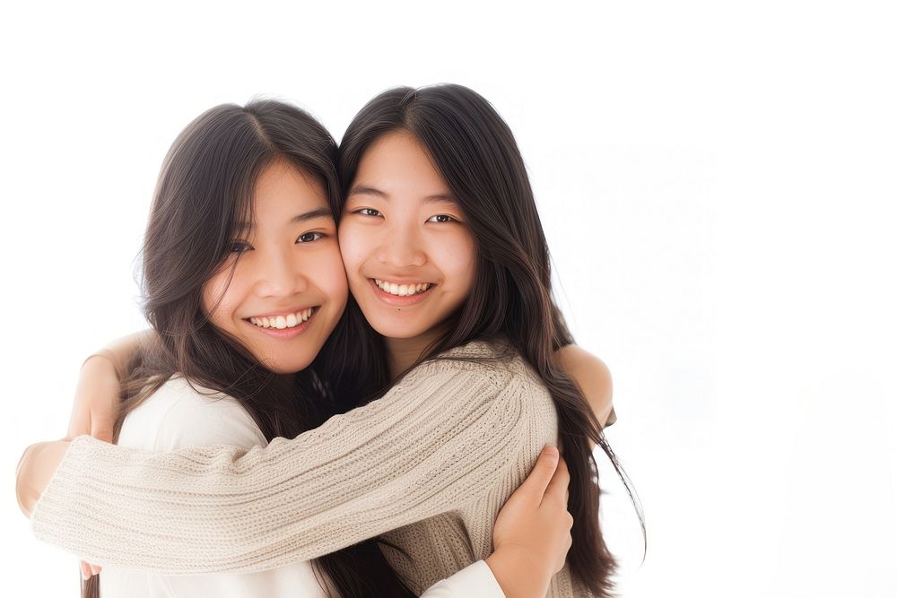 Two asian young women hugging smile adult white background.