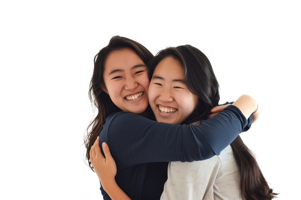 Two asian young women hugging laughing portrait adult.
