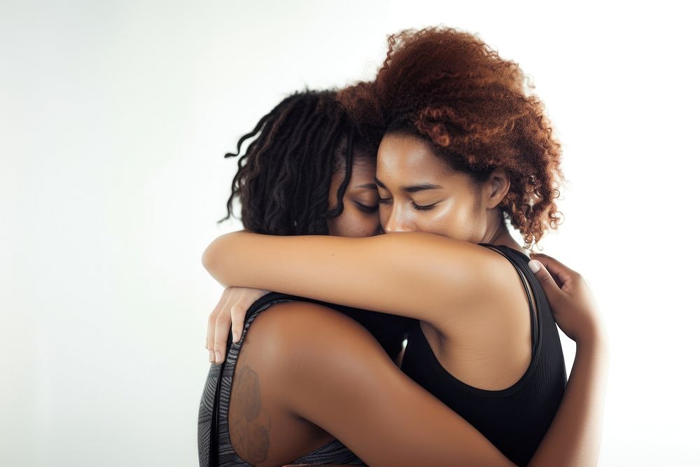 Two young women hugging adult back white background.