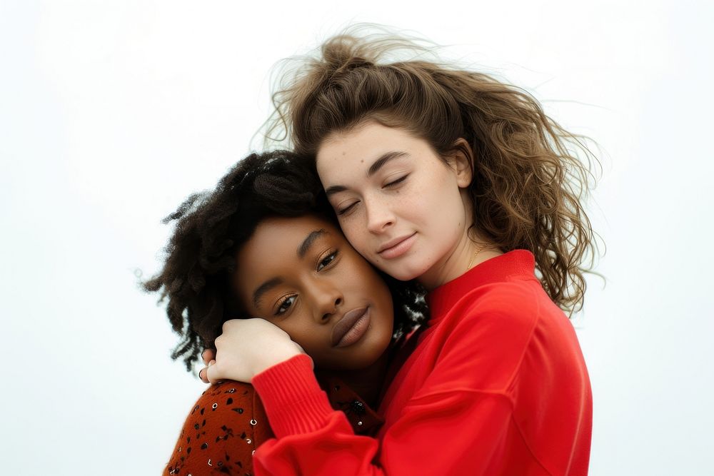 Two young women hugging portrait white background togetherness.