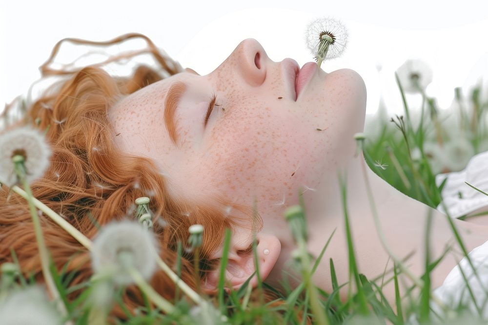 Young woman lying down on the field in green grass dandelion portrait flower.
