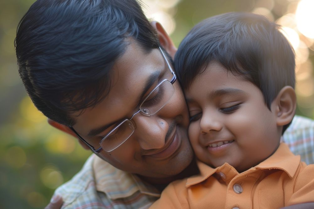 Indian dad and son portrait smiling glasses.