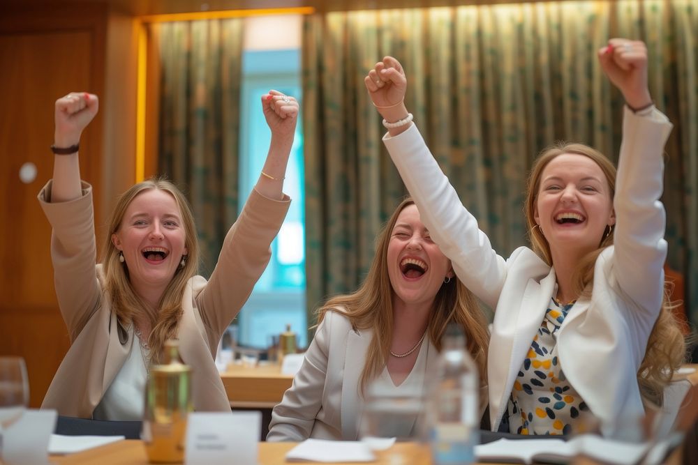 4 businesswomen cheering cheerful laughing smiling.