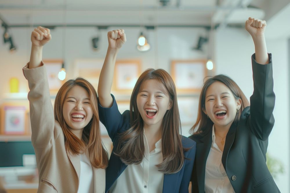4 businesswomen cheering cheerful laughing smiling.
