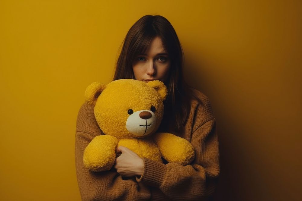 Holding teddy bear yellow adult toy.