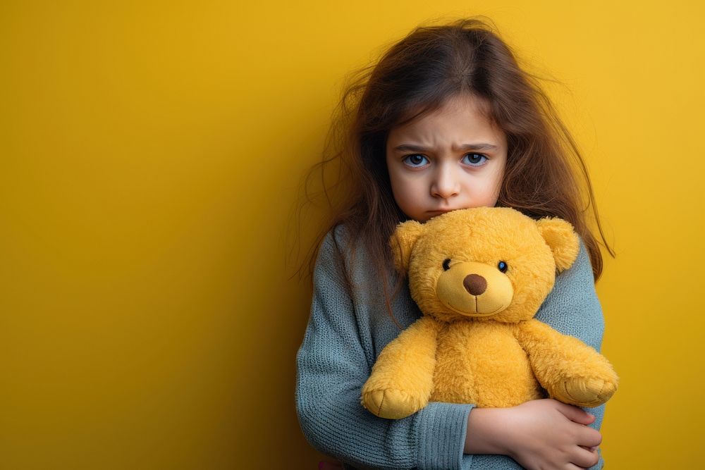 Holding teddy bear yellow child girl.