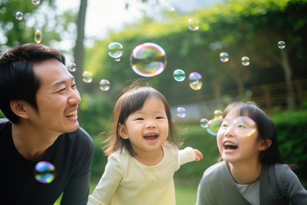 Asian family laughing portrait blowing.