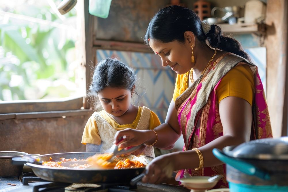 Indian mother helping a little girl cook food cooking kitchen child.
