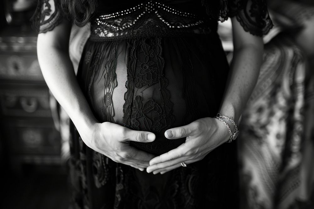 Pregnant woman holding her belly hand adult dress.