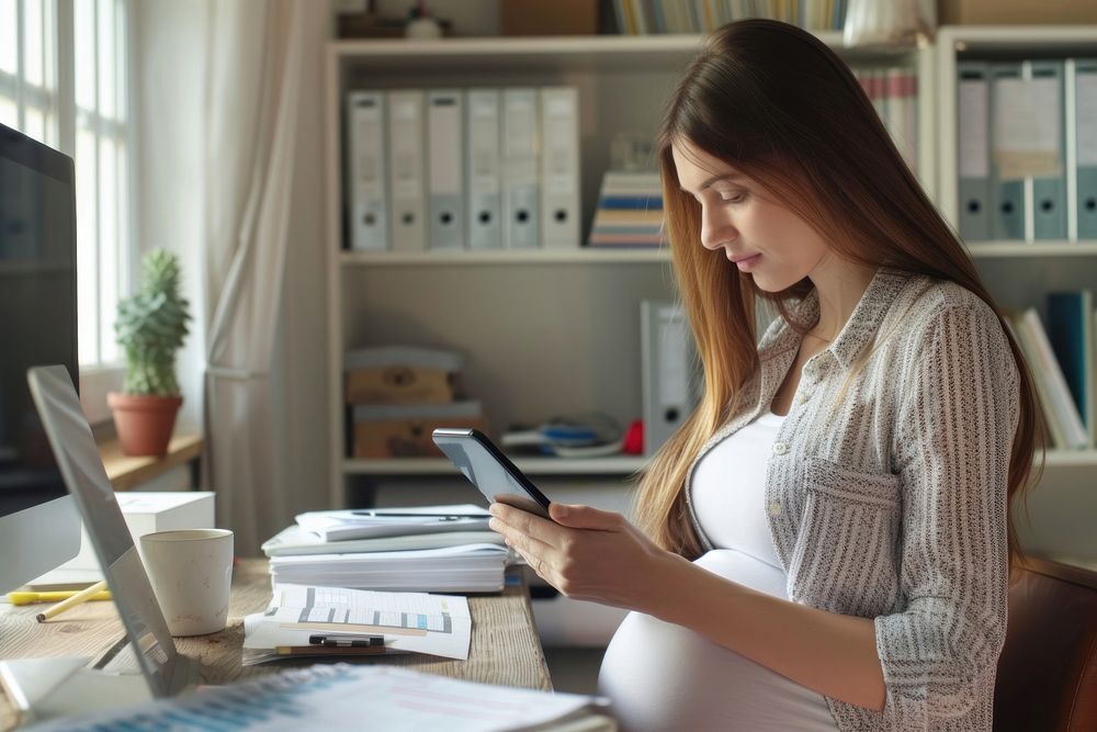 Pregnant woman checking furniture computer working.