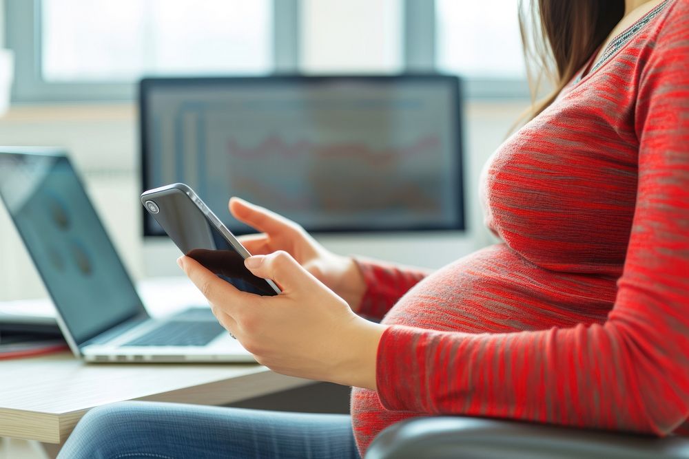 Pregnant woman checking computer working laptop.