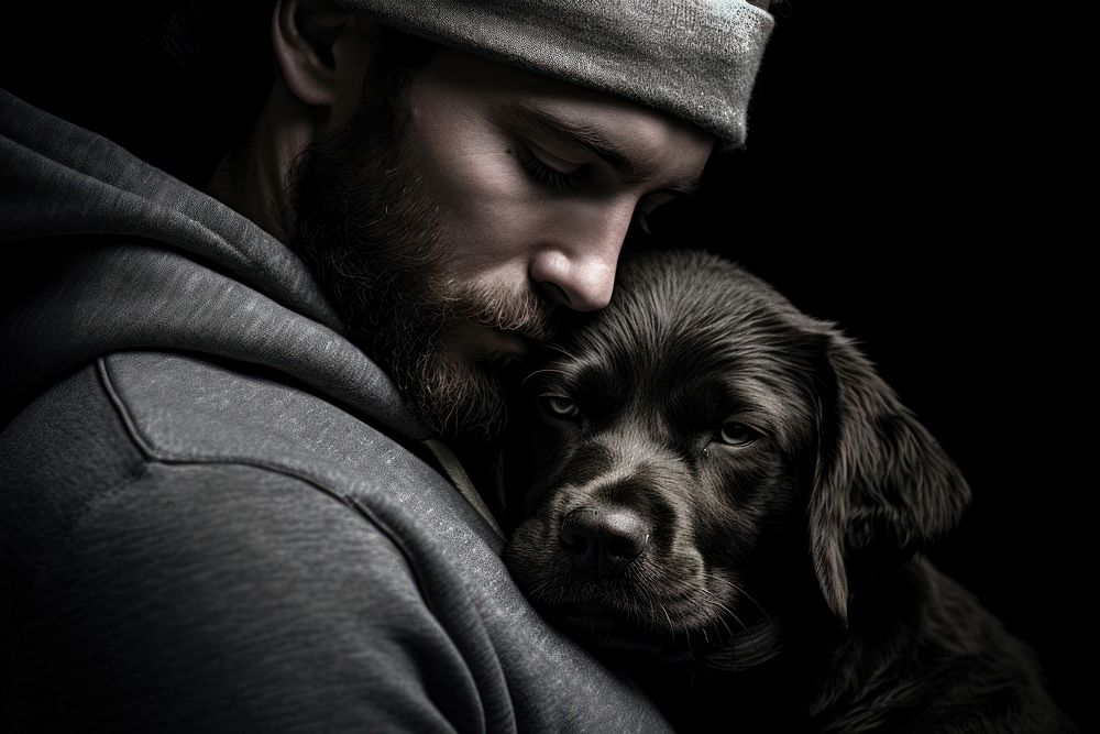 Person hugging a dog photography monochrome portrait.