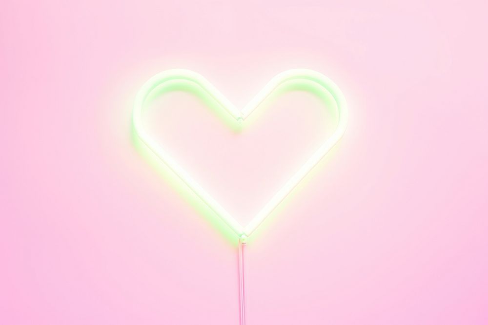 Pastel neon heart arrow light illuminated creativity.