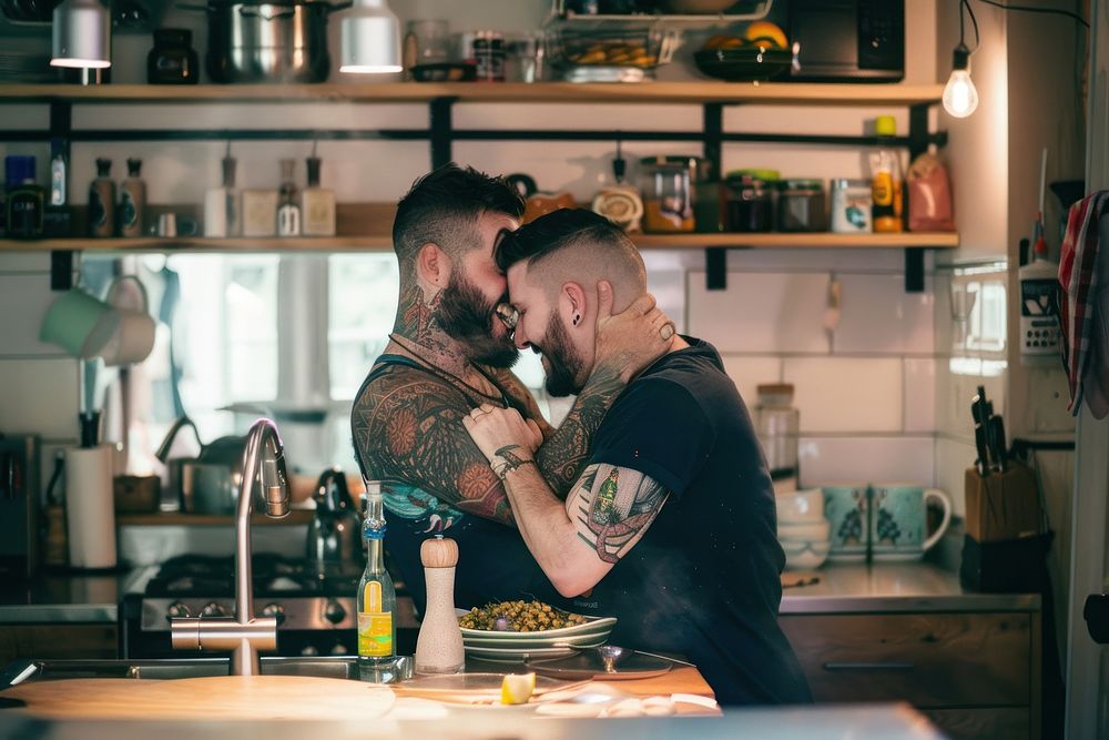 Gay couple kitchen kissing photo.