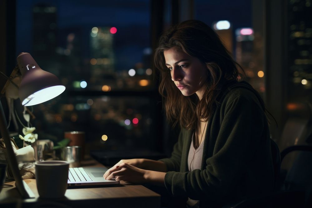 Woman works on her computer portrait lighting laptop.
