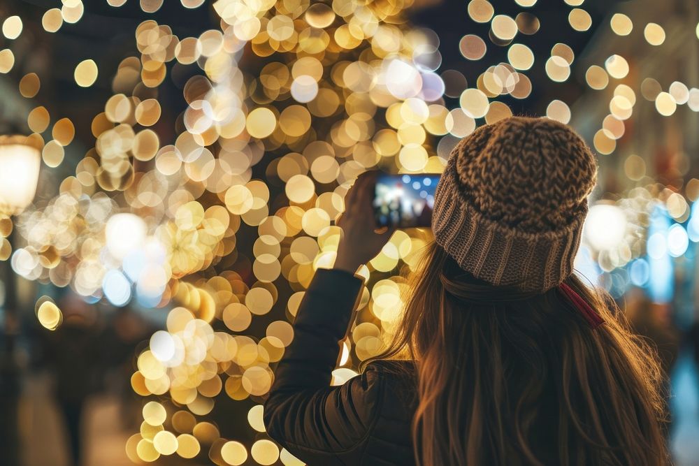 Photo of woman selfie christmas light night.