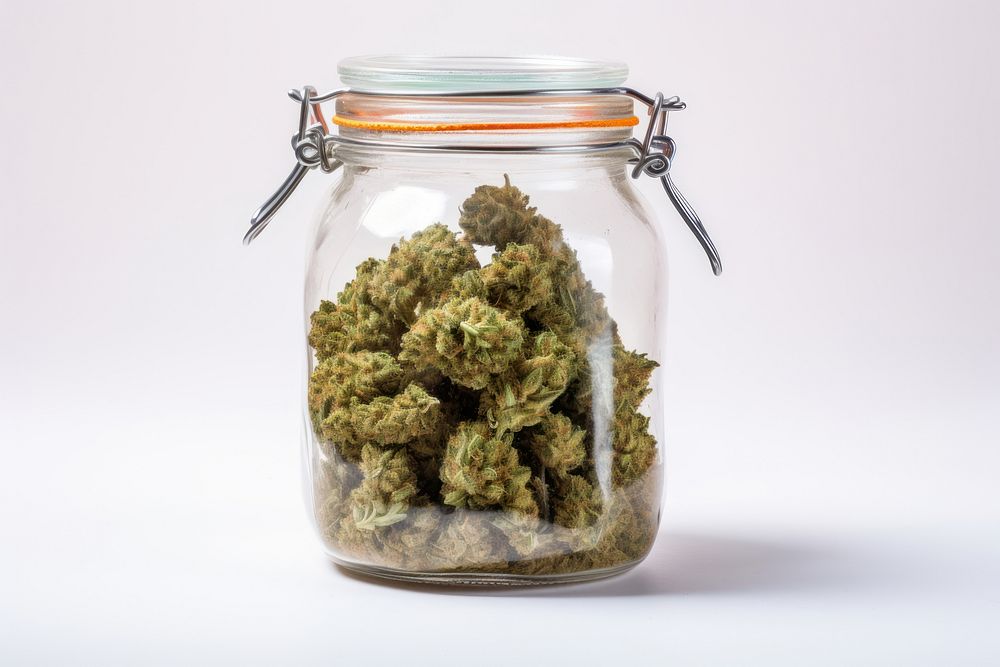 Cannabis in a glass jar cannabis plant white background.