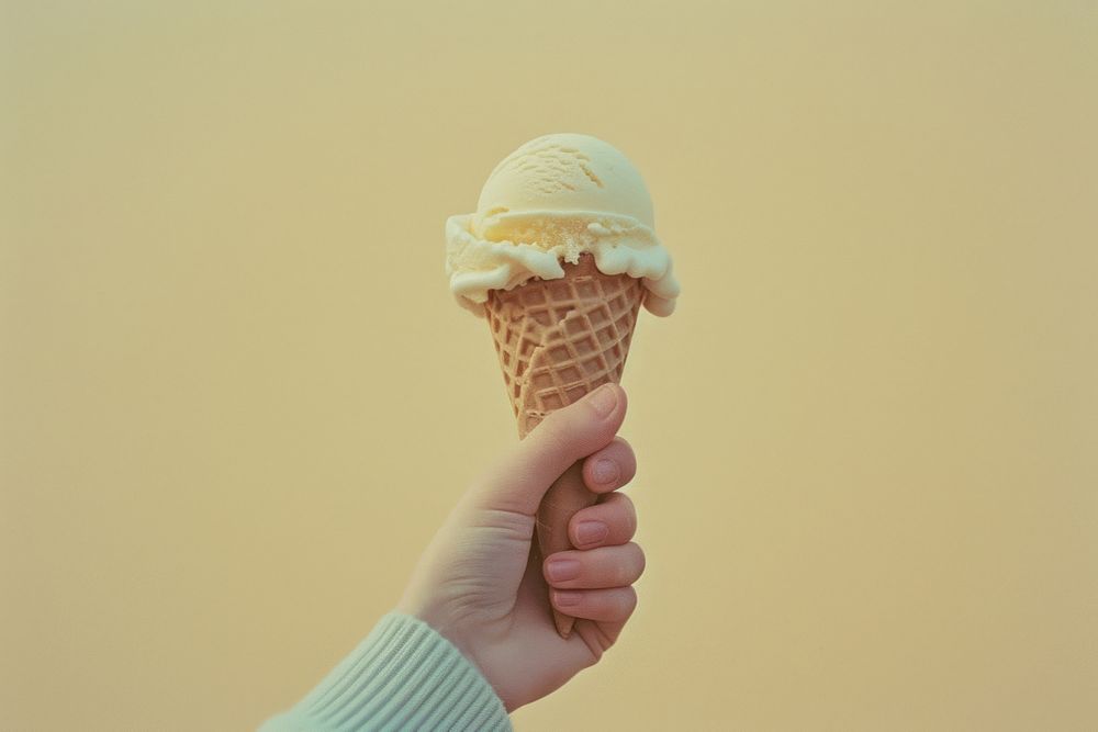 Hand holding icecream cone dessert food freshness.