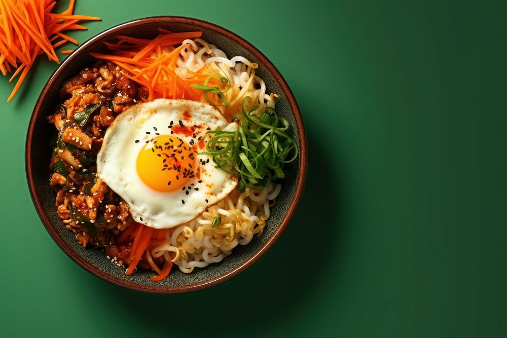 Bibimbab in a bowl plate food egg.