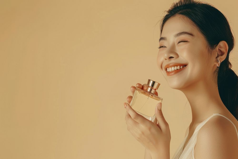 Woman smelling perfume smiling happiness hairstyle.