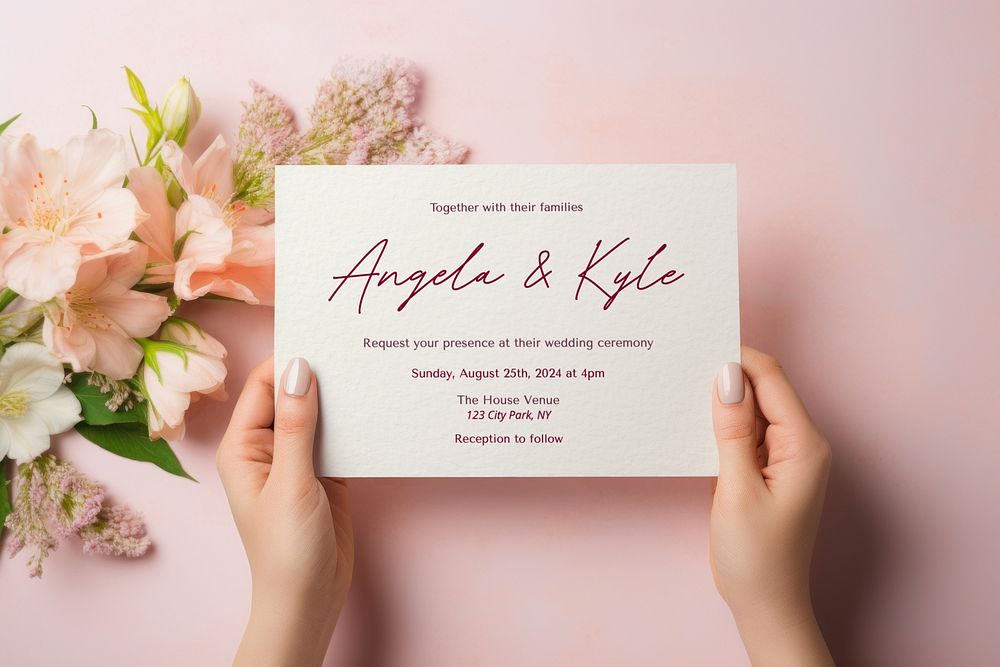 Woman holding wedding invitation card