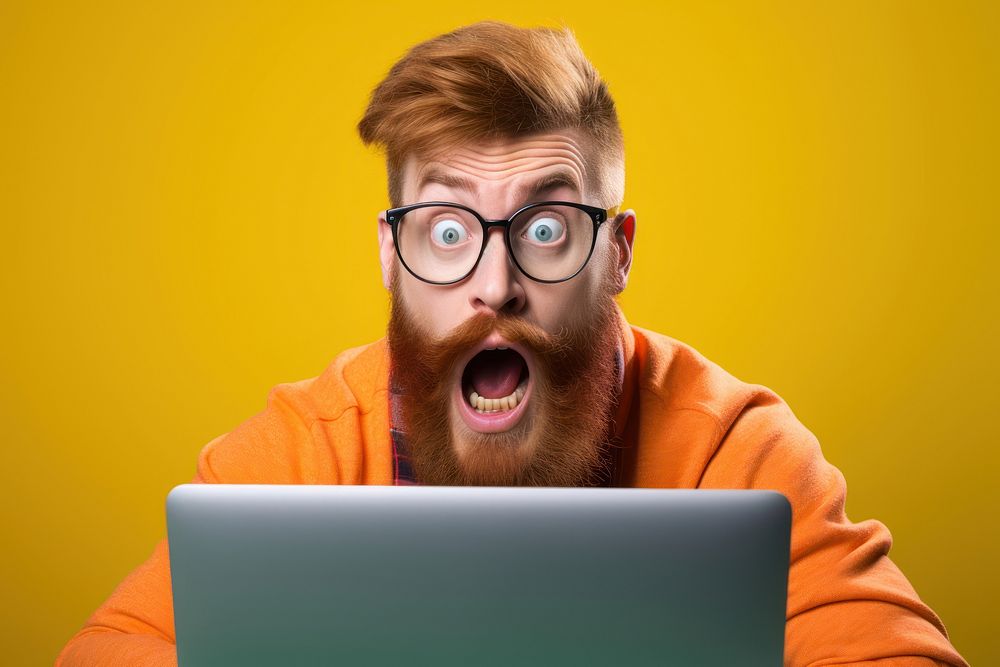 Man with ginger beard glasses surprised computer.