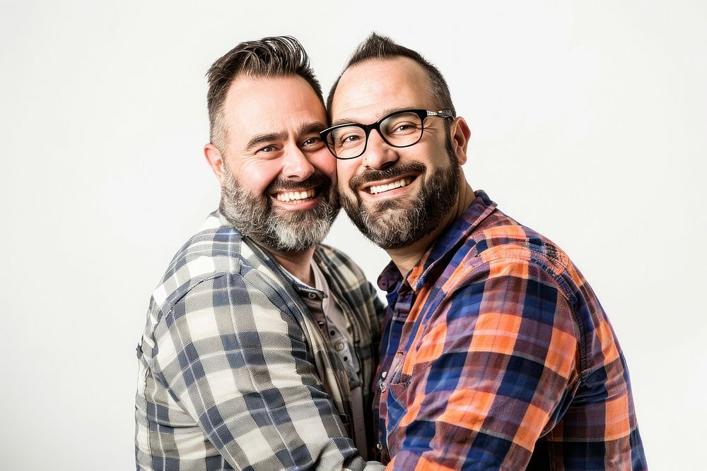 A gay couple laughing portrait glasses.