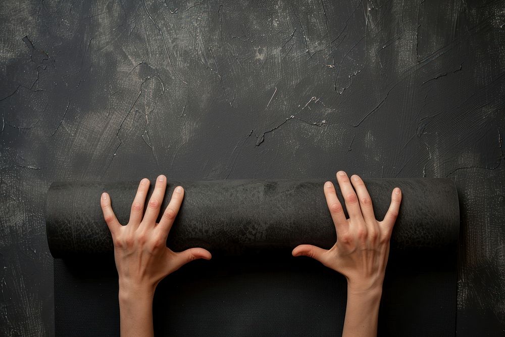 Person holding yoga mat finger blackboard person.