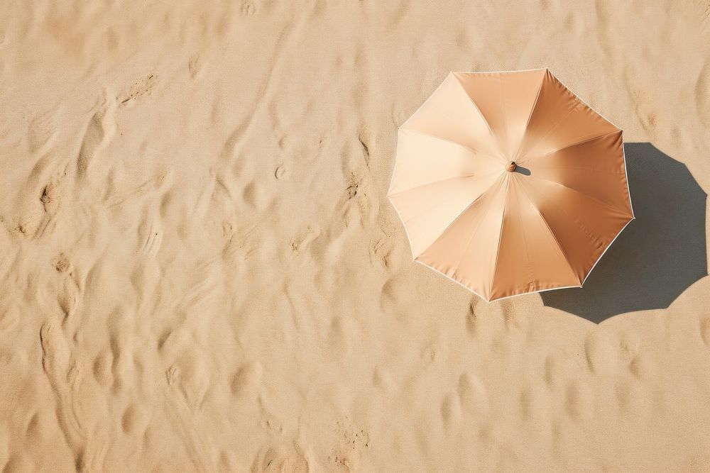 Beach umbrella on sand backgrounds outdoors nature.