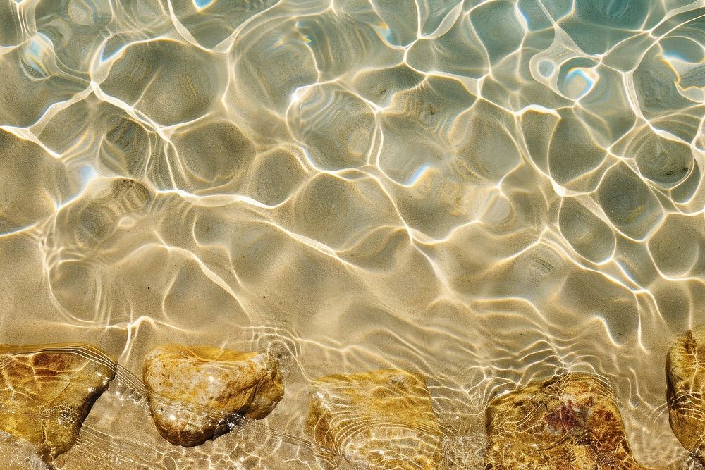 Water pattern on earth tone sand backgrounds underwater outdoors.