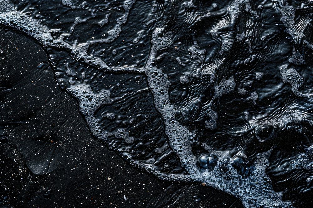 Water pattern on black sand backgrounds outdoors nature.