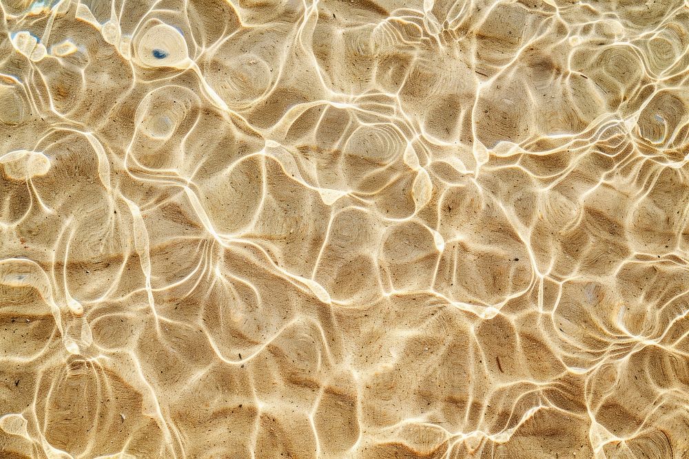 Water pattern on brown sand backgrounds outdoors texture.