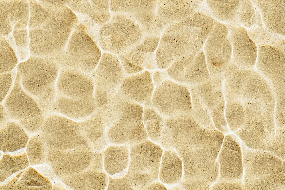 Water pattern on beige sand backgrounds texture magnification.