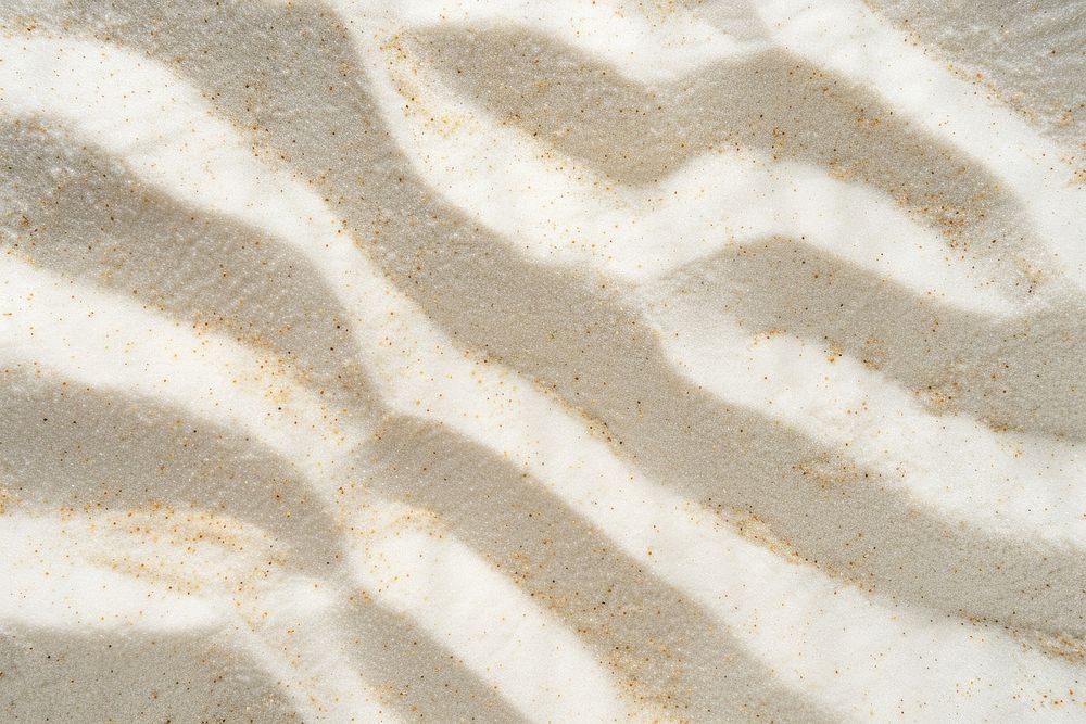 Wishbone pattern on white sand backgrounds outdoors texture.