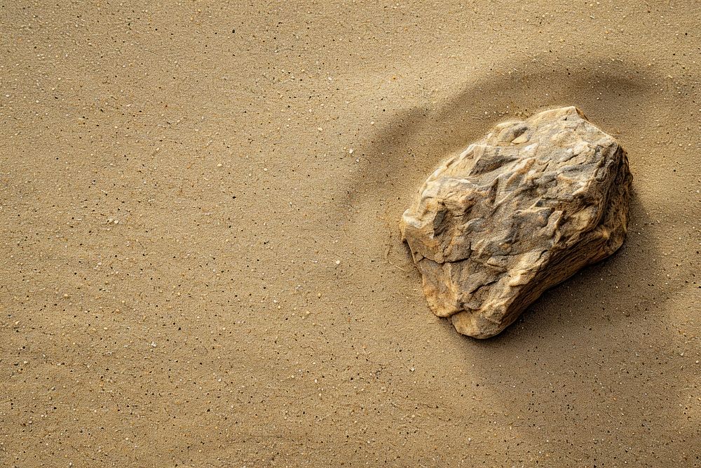 Zen rock on sand outdoors nature ground.