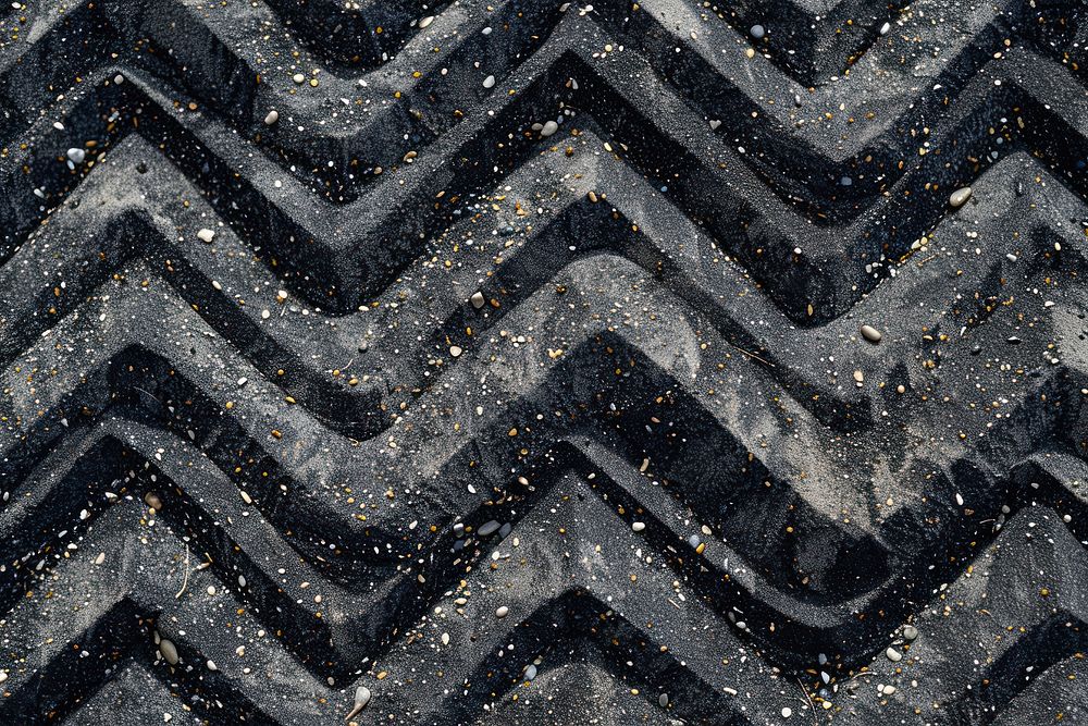 Zig zag pattern on black sand backgrounds texture textured.