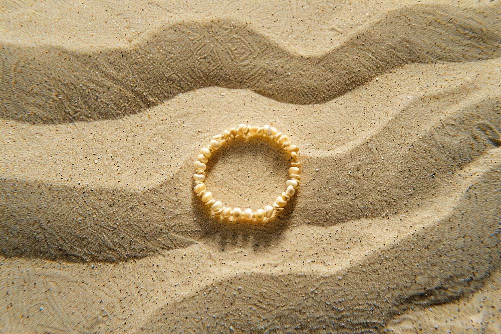 Bracelet on sand outdoors jewelry nature.