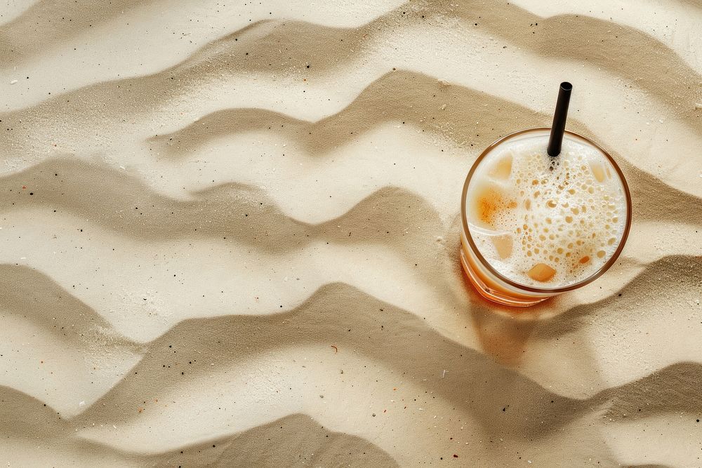Cocktail on sand backgrounds coffee drink.